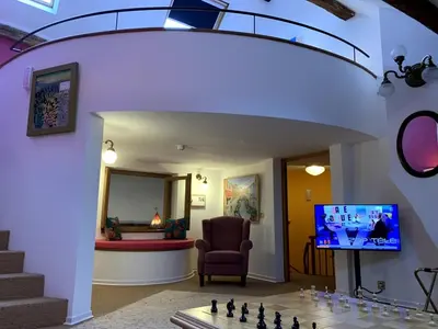 a living room with a chess board and a tv at Gite de Caractère Le Lys Bleu in Limbourg
