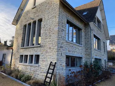 a brick house with a ladder in front of it at Le Retour aux Sources - Chambre d'Hôte chaleureuse et conviviale in Chaudfontaine