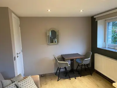 a small dining room with a table and chairs at Le Retour aux Sources - Chambre d'Hôte chaleureuse et conviviale in Chaudfontaine