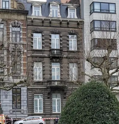 a large brick building with a car parked in front of it at Le Piercot in Liège