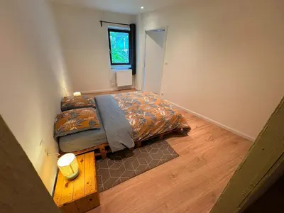 a small bedroom with a bed and a window at Le Piercot in Liège
