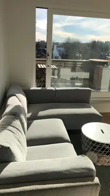a group of couches in a room with a window at Gezellig 1 slaapkamer appartement nabij het stadscentrum in Hasselt