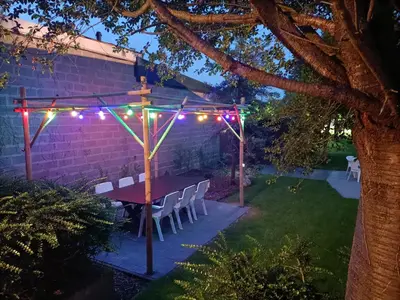 a table in a garden with lights on it at Moodraz vakantiehuis centrum Peer in Peer