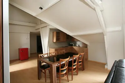 a kitchen with a table and chairs in a room at Hotel Au Prince Royal in Leopoldsburg