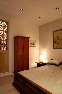 a bedroom with a bed and a cabinet and a window at Wabi Sabi B&B in Peer