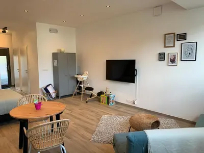 a living room with a couch and a table at Green studio-Situé à 15 min de Botrange, Parc Hautes Fa gnes et Francorchamps in Heusy