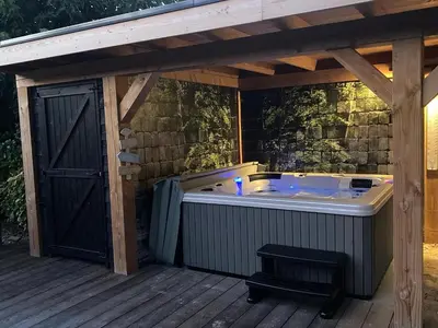 a jacuzzi tub on a wooden deck at Rue Haute by M&M 4 sterren bed en breakfast vlakbij Maastricht in Eben-Emael