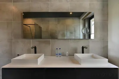 a bathroom with two sinks and a mirror at Rue Haute by M&M 4 sterren bed en breakfast vlakbij Maastricht in Eben-Emael