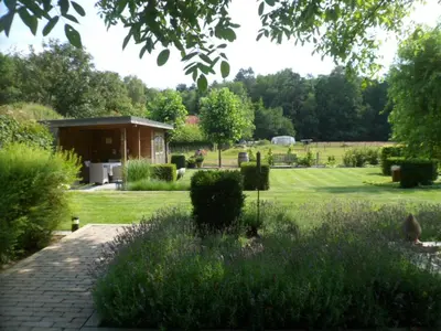 a garden with a pavilion in the background at Bosrand81 in Hechtel