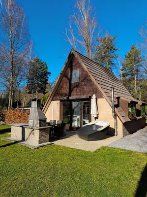a building with a fountain in the grass at Lauwie 14 in Lanaken