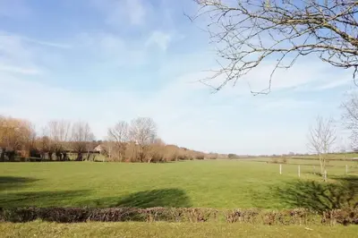 a large green field with trees in the distance at ländlich & gemütlich in Raeren mit 2 Schlafzimmern in Raeren