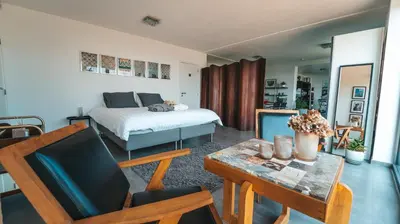 a living room with a bed and a table and a table sidx sidx at Les Croisettes 88, design loft XXL with amazing vue for peaceful stay in Trooz