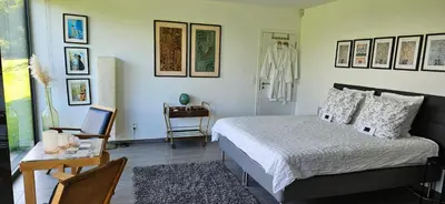 a bedroom with a bed and a table and a desk at Les Croisettes 88, design loft XXL with amazing vue for peaceful stay in Trooz