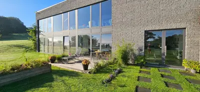 a brick house with a garden in front of it at Les Croisettes 88, design loft XXL with amazing vue for peaceful stay in Trooz