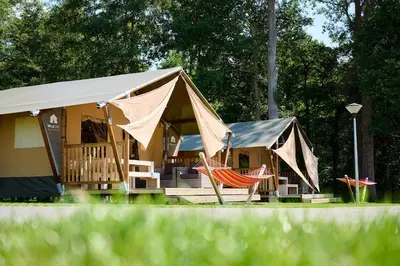 a tent with two hammocks in front of it at Glamping Belgisch Limburg in Oudsbergen