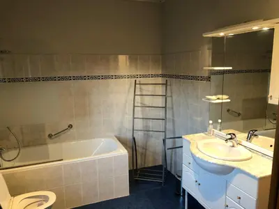 a bathroom with a tub and a sink at Hoeve de Singel in Borgloon