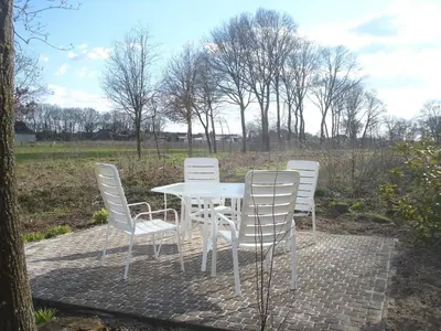 a white table and chairs on a brick patio at Elegant & Peaceful Holiday Retreat in Peer in Peer