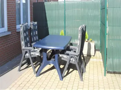 a blue table and two chairs on a patio at Elegant & Peaceful Holiday Retreat in Peer in Peer