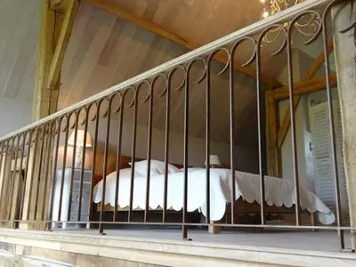 a bed with a metal railing on a balcony at B&B Hoeve Ransberg in Ransberg