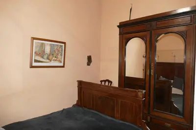 a bedroom with a wooden dresser and a mirror at Apartments Cour d'Aix in Richelle