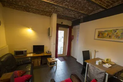 a living room with a couch and a table at Apartments Cour d'Aix in Richelle