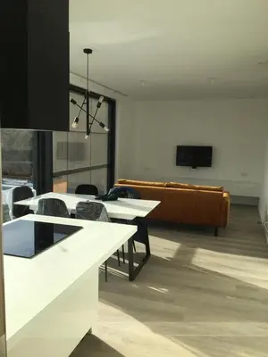 a living room with tables and a couch and a tv at Gods Heide in Hasselt