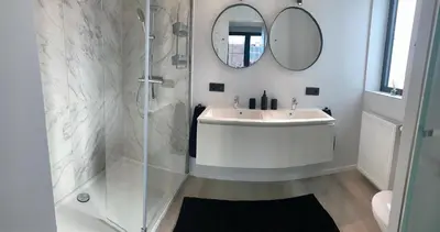 a white bathroom with a sink and a mirror at Gods Heide in Hasselt