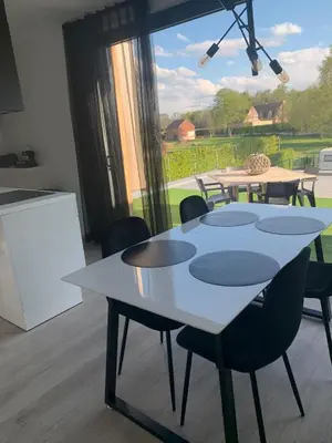 a white table and chairs in a room with a window at Gods Heide in Hasselt
