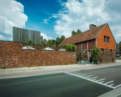 a brick building on the side of a road at Hotel Restaurant Vous lé Vous in Hasselt