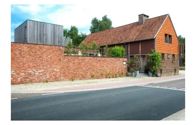 a brick building on the side of a road at Hotel Restaurant Vous lé Vous in Hasselt