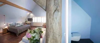a room with a bed and a table with flowers at Hotel Restaurant Vous lé Vous in Hasselt