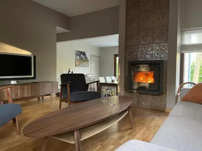 a living room with a table and a fireplace at Sterrenheide in Heusden - Zolder