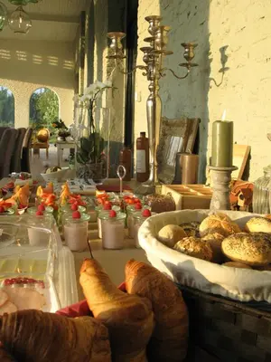 a table with bread and pastries on it at B&B Amuse-Couche in Hasselt