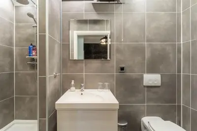 a bathroom with a sink and a toilet at B&B De Kroonhoeve in Beringen