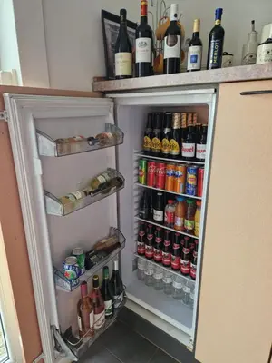 a refrigerator filled with lots of bottles of alcohol at B&B De Kroonhoeve in Beringen