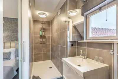 a bathroom with a sink and a shower at B&B De Kroonhoeve in Beringen
