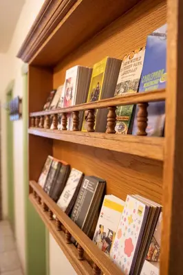 a book shelf filled with lots of books at Hotel Monika in Zutendaal