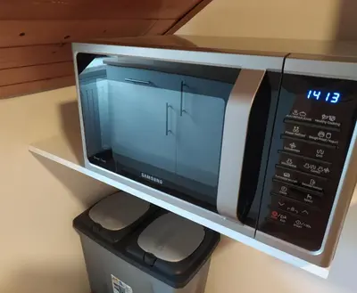 a microwave oven sitting on top of a shelf at Wonderwall in Houthalen-Helchteren