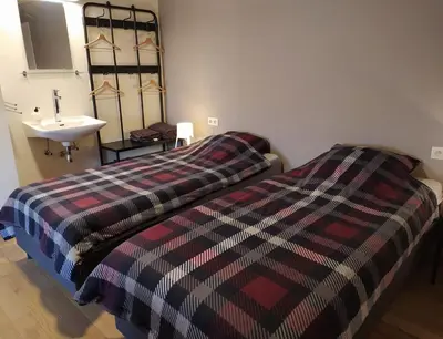 a bedroom with a bed and a sink in it at Wonderwall in Houthalen-Helchteren