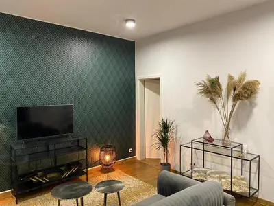 a living room with a couch and a flat screen tv at Cozy apt w/ king bed great for discovering Liege in Liège