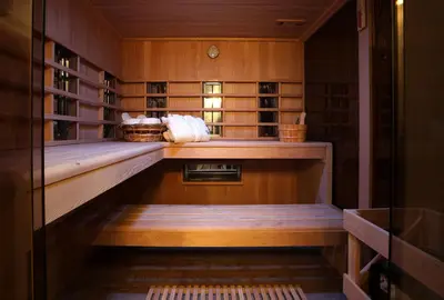 a library with wooden walls and shelves in a room at Marias Guest House in Eynatten