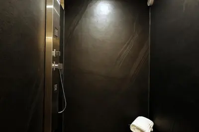 a bathroom with a shower stall with a toilet at Marias Guest House in Eynatten