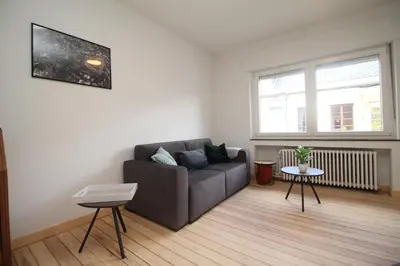a living room with a couch and a window at Appart Nicolas in Eupen