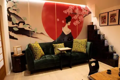 a living room with a green couch and a large painting at 1 Bed Villa - Sleeps 2 - Garden - Parking - Wifi in Grote-Brogel