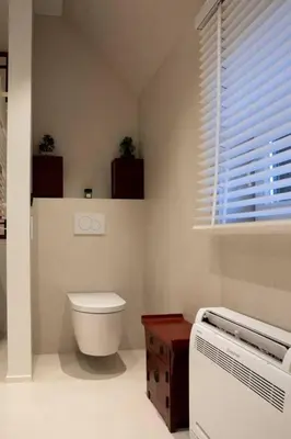 a bathroom with a toilet and a window at 1 Bed Villa - Sleeps 2 - Garden - Parking - Wifi in Grote-Brogel