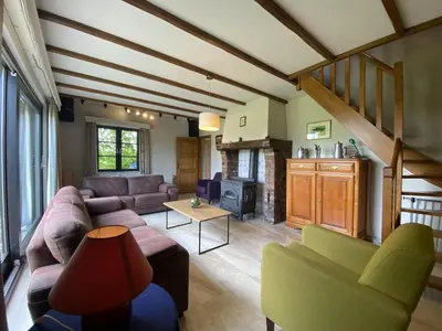 a living room with a couch and a table at Drieskenshoeve in Grote-Brogel