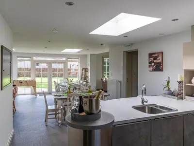 a kitchen and living room with a dining room at Secretarishuis in Peer