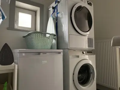 a laundry room with a washing machine and a dryer at Vakantiewoning Mèzik in Maasmechelen