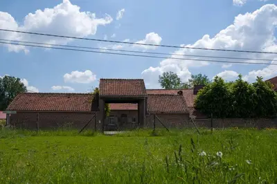 a brick house with a green field in front of it at Glabbeek-hoeve in Geetbets