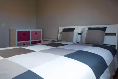 a bedroom with a large bed in a room at Glabbeek-hoeve in Geetbets